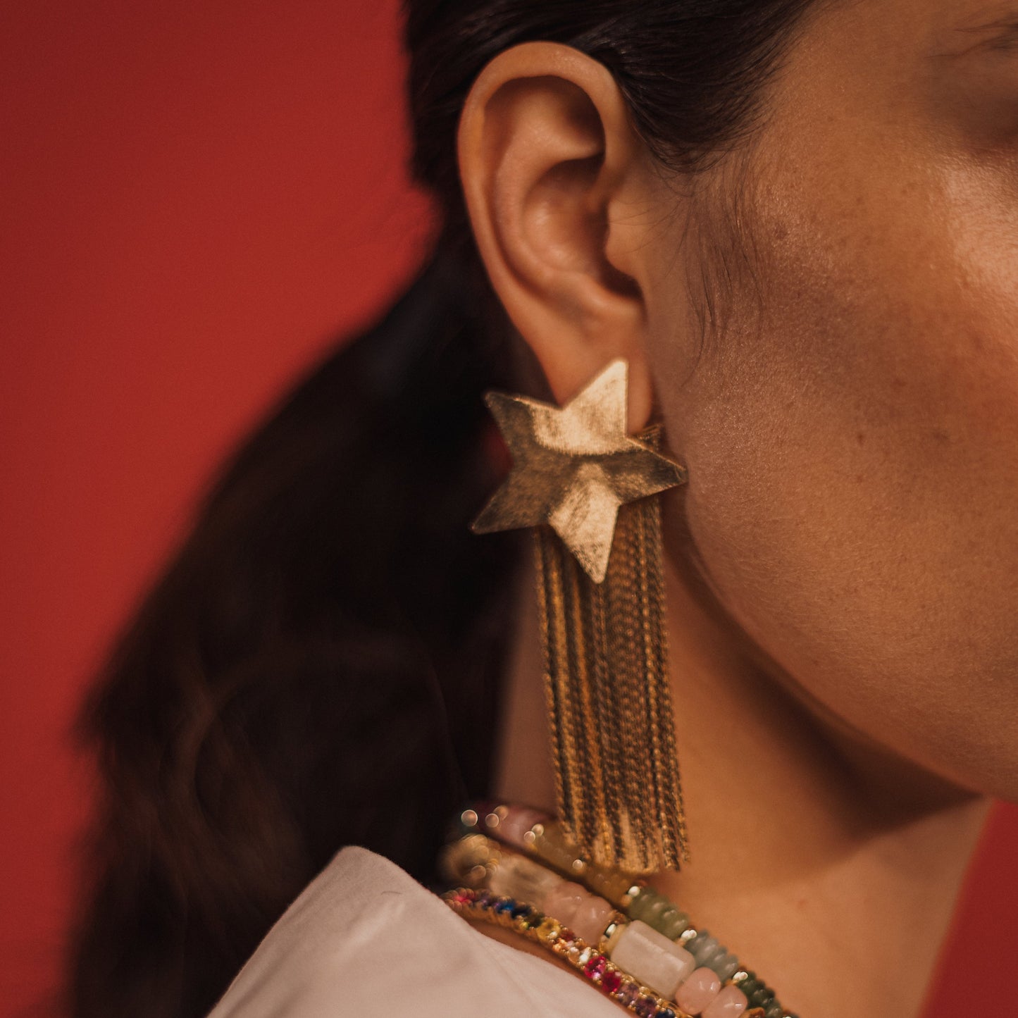 Aretes dorados Emblema
